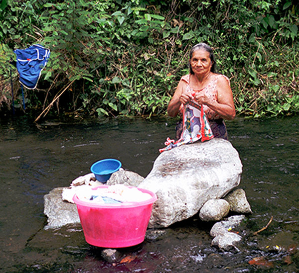 Woman Washing Clothes in 4th of July Community